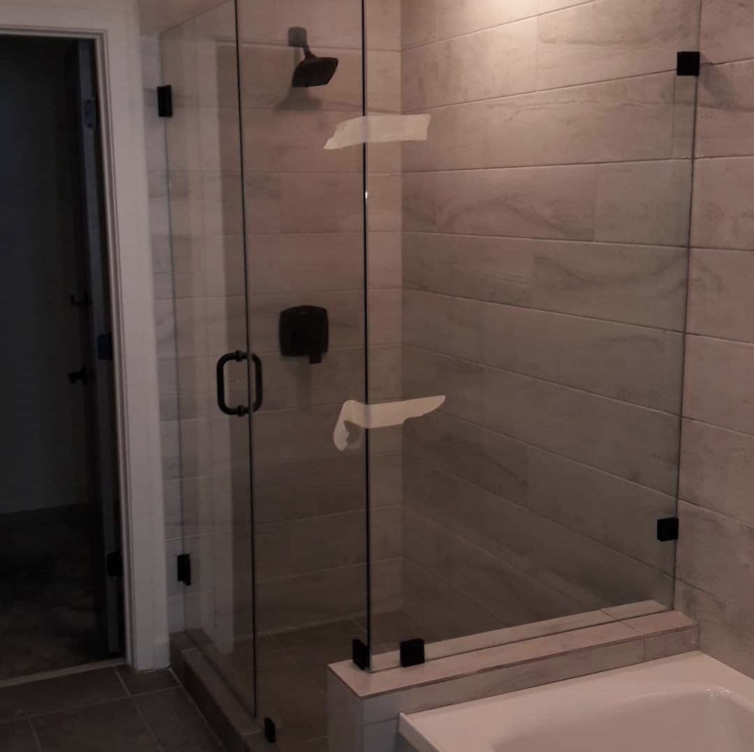 Corner shower with black clamps