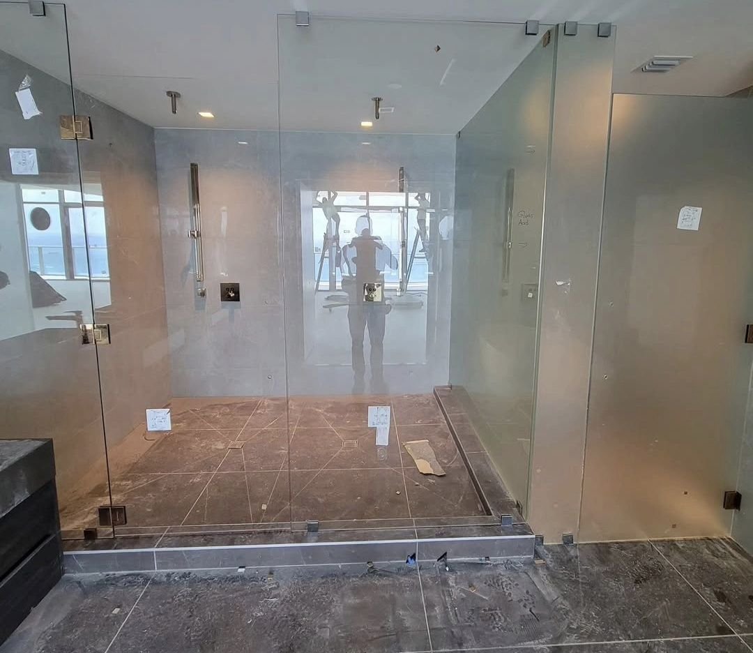 Large shower enclosure during installation in a high-rise unit